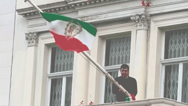 protester scales iranian embassy in london tears down regime flag hoists pre revolution symbol 6962d20d79cd0