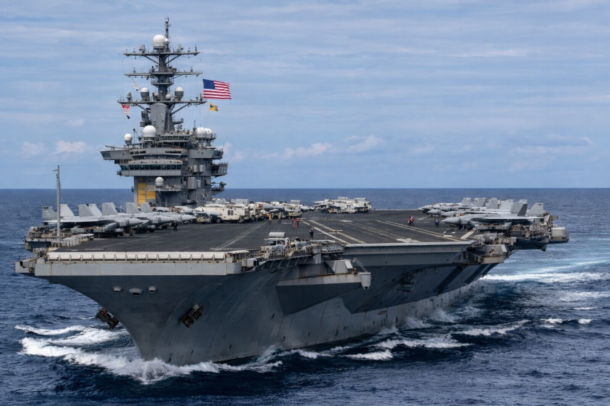 U.S. Navy aircraft carrier operating in open waters, symbolizing American military deterrence and strategic presence in the Middle East.