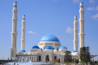 The Grand Astana Mosque in Astana, Kazakhstan, one of Central Asia’s largest Islamic landmarks, featuring its monumental blue dome and 130-meter minarets.